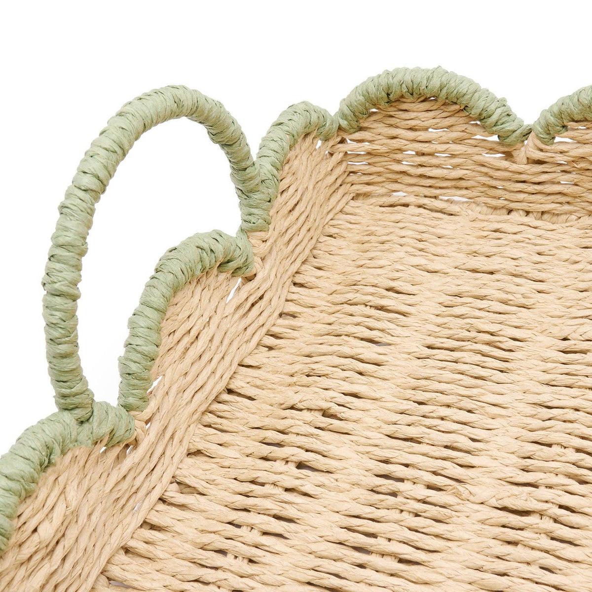 Handwoven scalloped green edge tray styled on a table