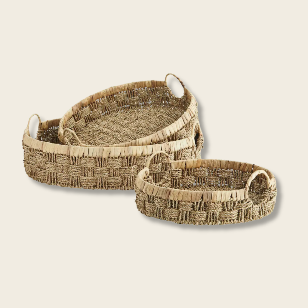 Set of three woven baskets with handles on a white background