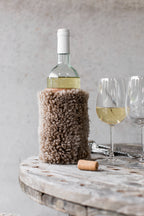 Brown sheepskin wine cooler with a genuine leather base