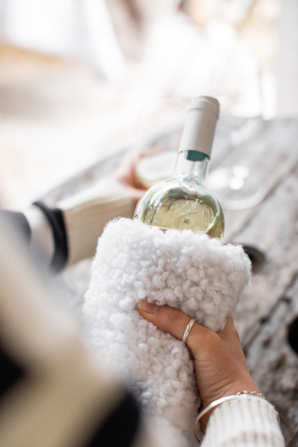 Sheepskin wine cooler holding a bottle of wine