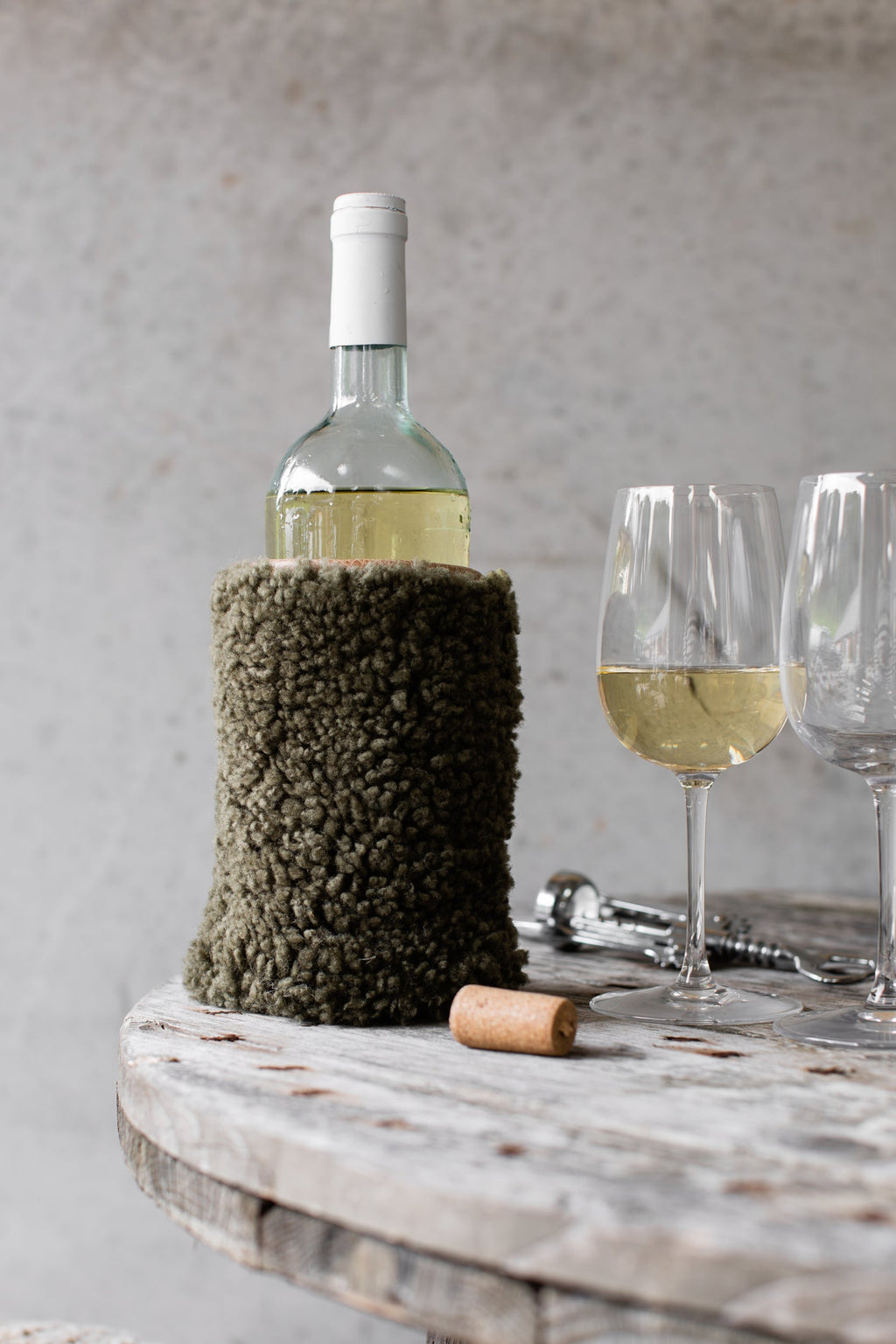 Olive sheepskin wine cooler with a genuine leather base