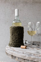 Olive sheepskin wine cooler with a genuine leather base