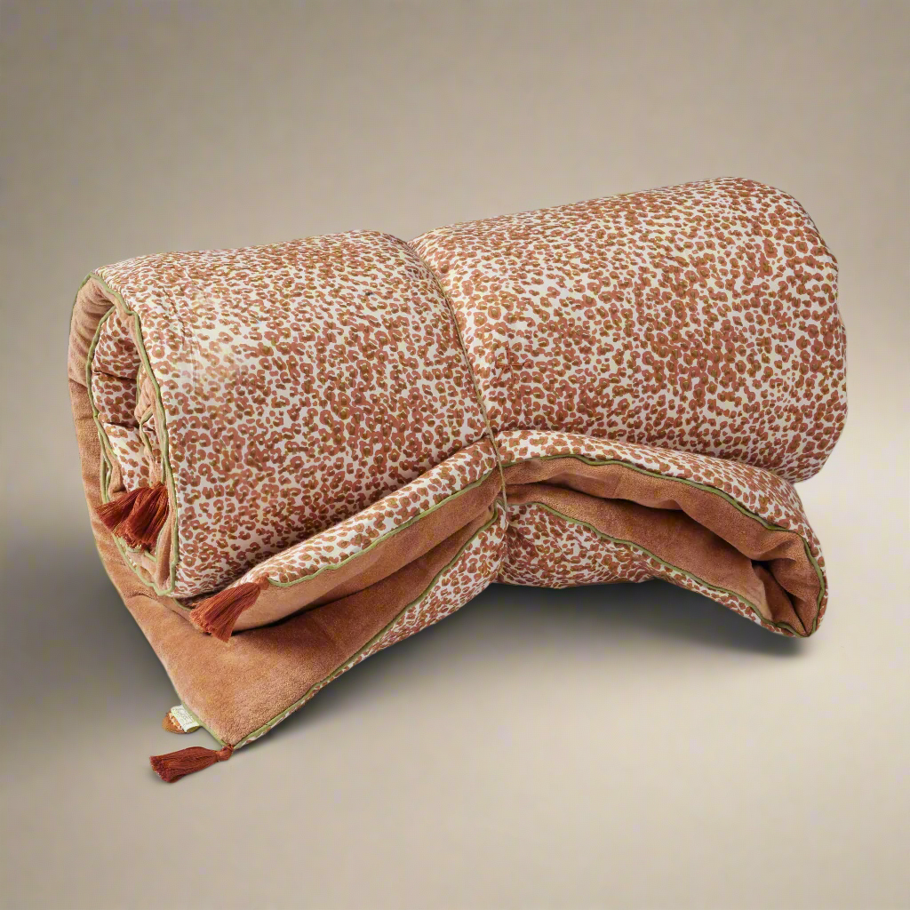 padded sofa throw rolled and tied with a string.