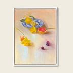 Framed artwork of a still life with lemons, flowers, and fruit on a light background