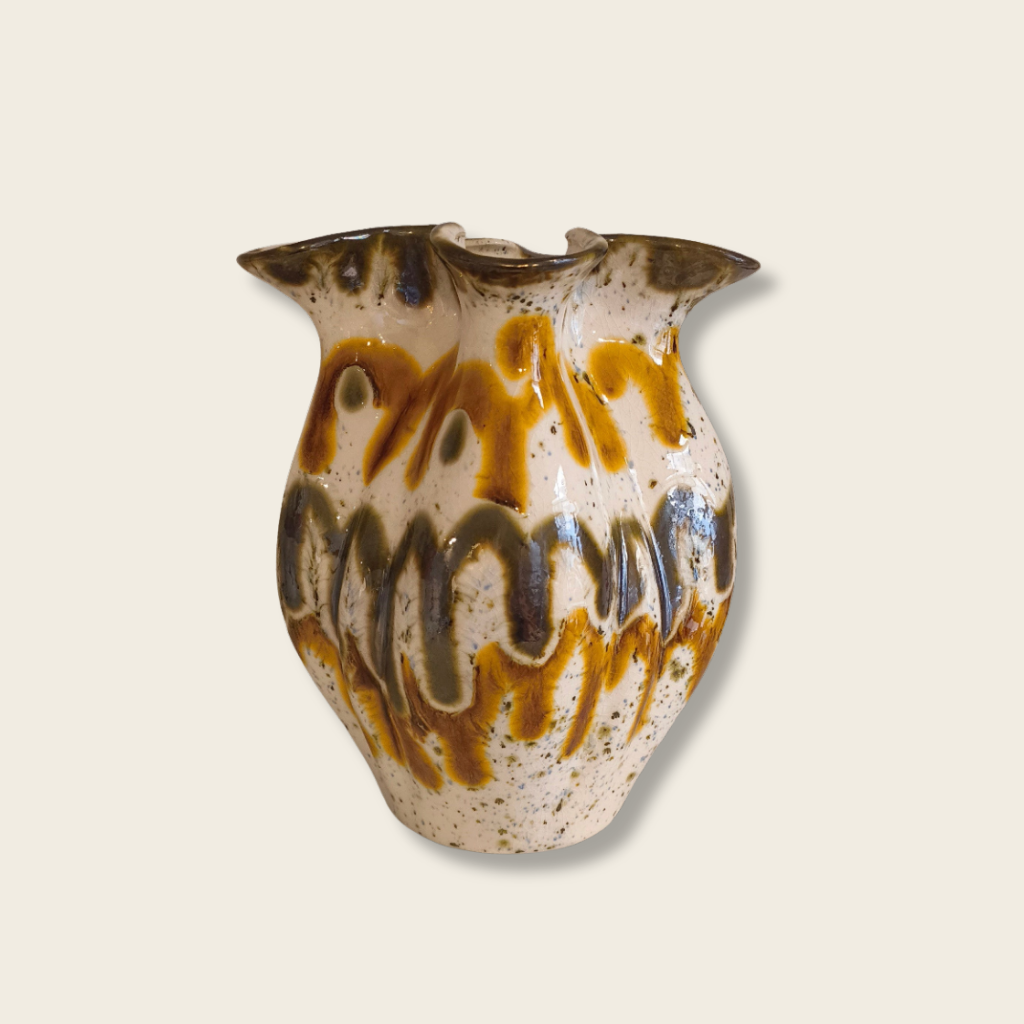 Ceramic vase with brown and beige patterns on a light beige background