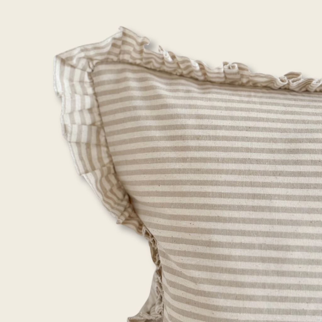 Close-up of a striped fabric with ruffled edges on a light background
