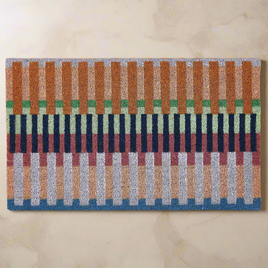Colorful striped doormat with a geometric pattern on a white background