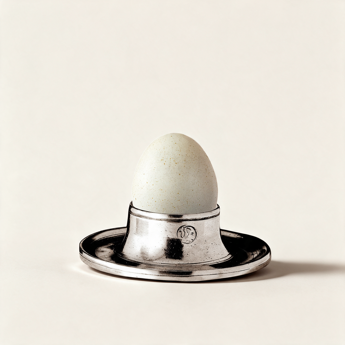 Stromboli pewter egg cup on a warm cream background
