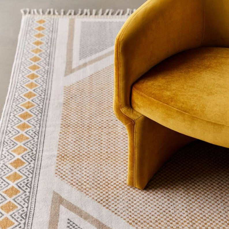 Yellow chair on a patterned rug with geometric designs