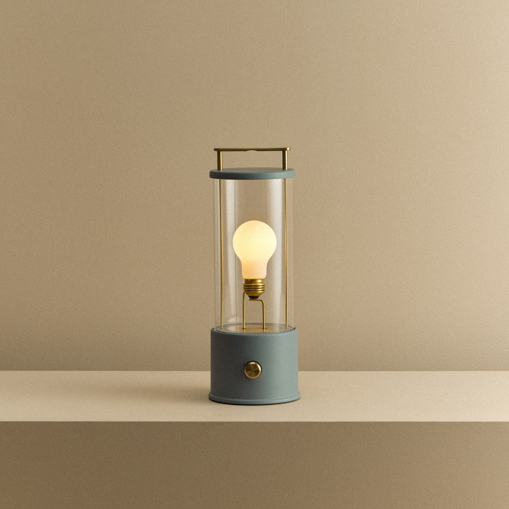 Modern lantern-style lamp with a lit bulb on a beige background