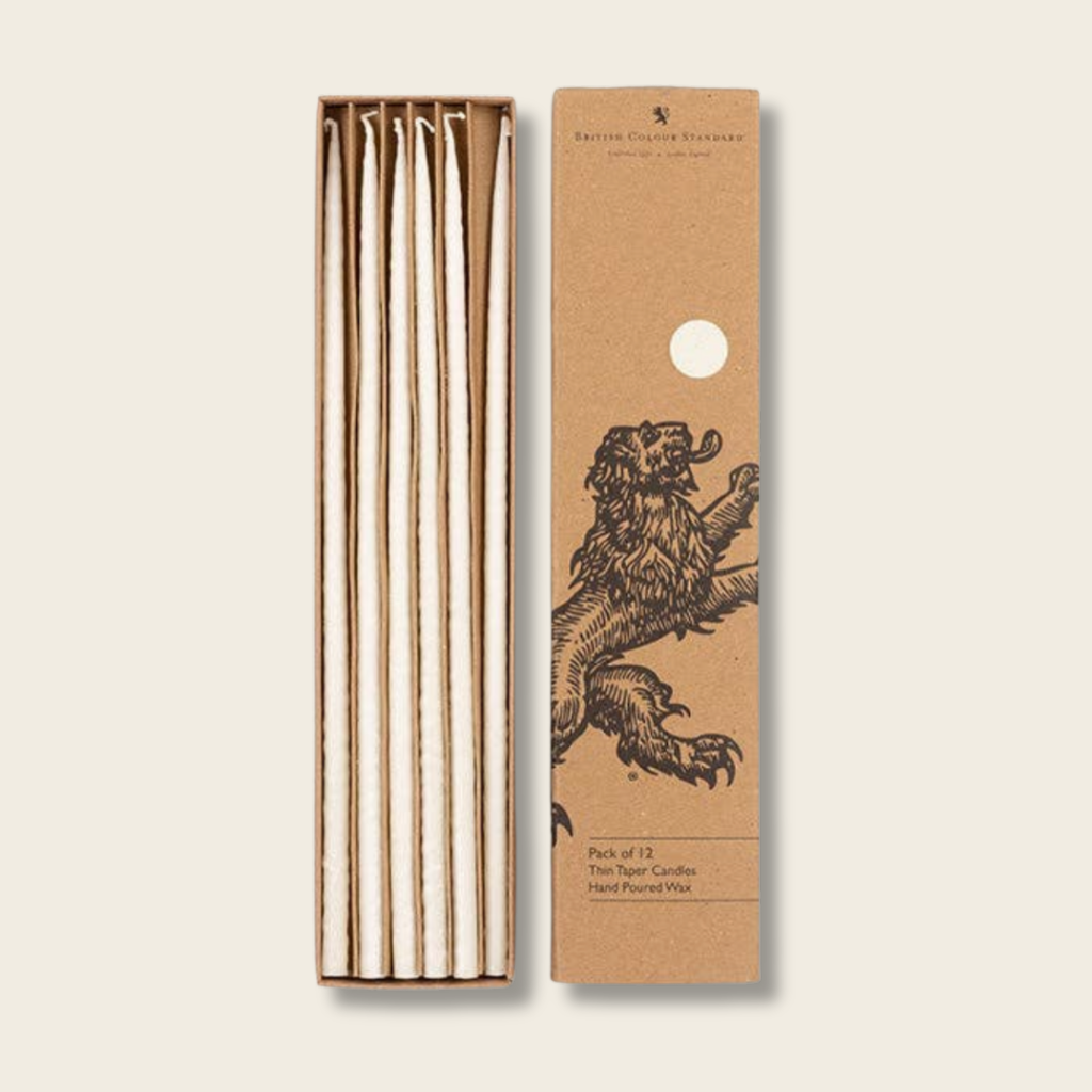 Set of candles in a cardboard box with a lion illustration on a beige background