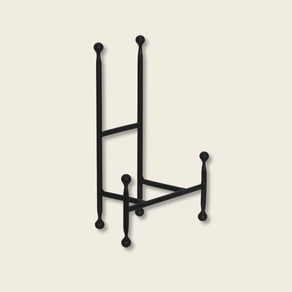 chair easel in black iron on a beige background