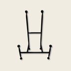 Black iron chair easel on a beige background