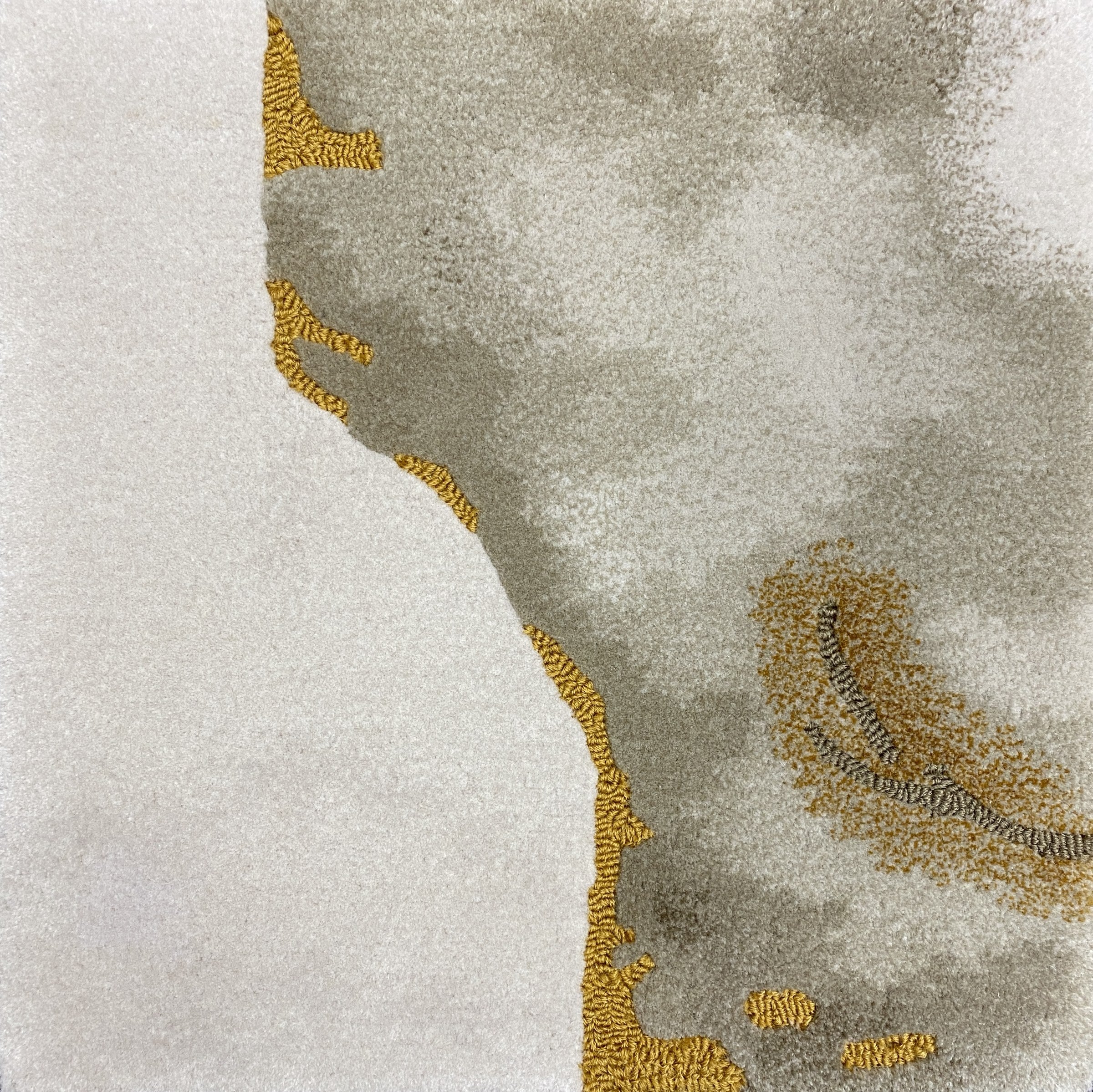 Detail of the Terra rug pile in cream and stone with gold veins