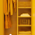 Yellow wardrobe with clothes and storage baskets