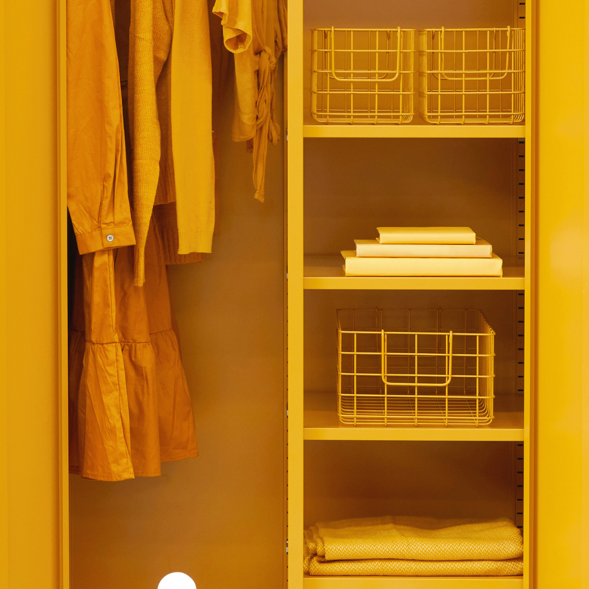 Yellow wardrobe with clothes and storage baskets