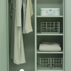 Green wardrobe with clothes and storage baskets