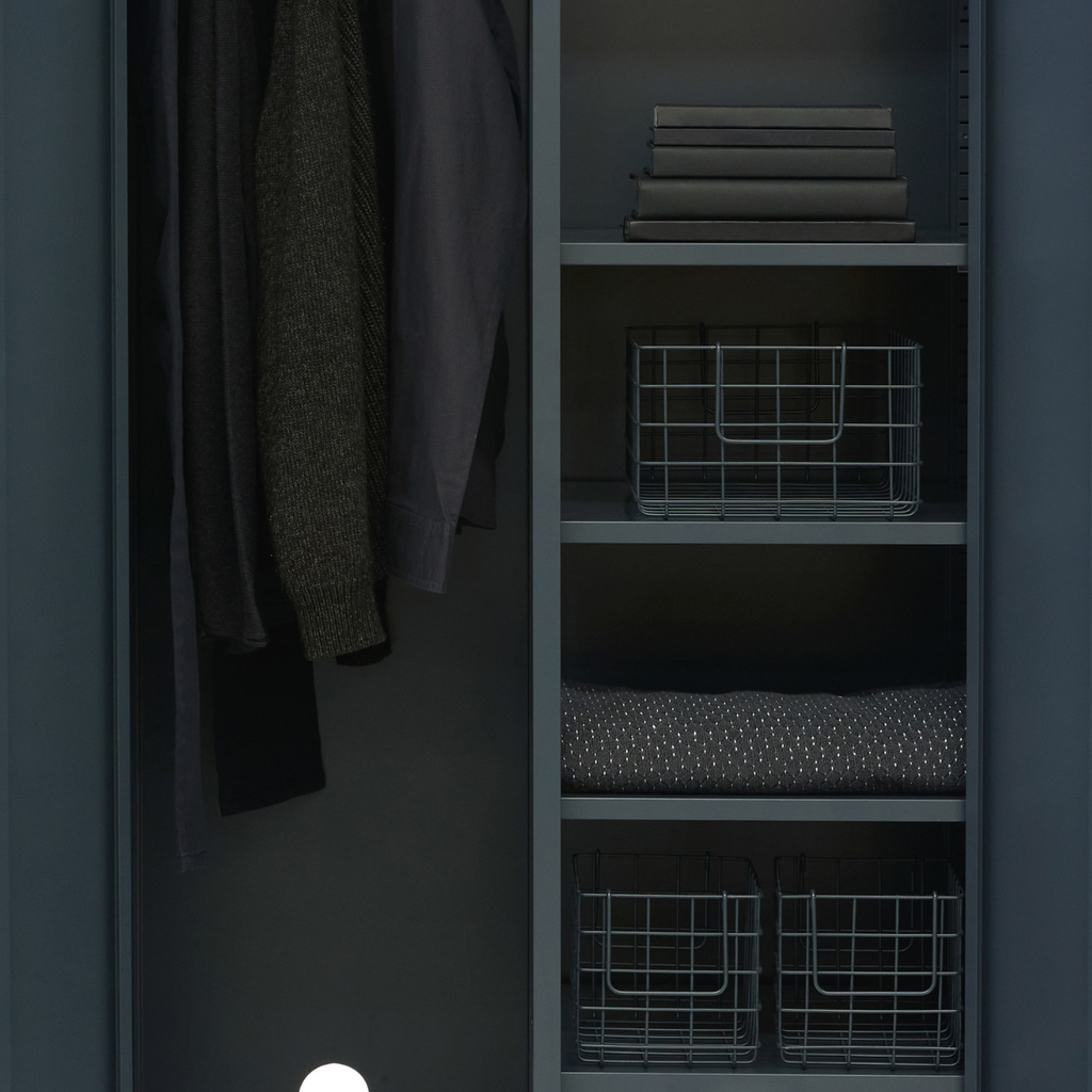 Closet with shelves and clothes, dimly lit