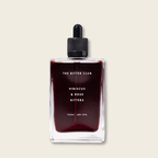 Bottle of The Bitter Club Hibiscus & Rose Bitters on a beige background