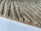 Close up of the Trace oyster rug showing the cut pile and fine contour lines