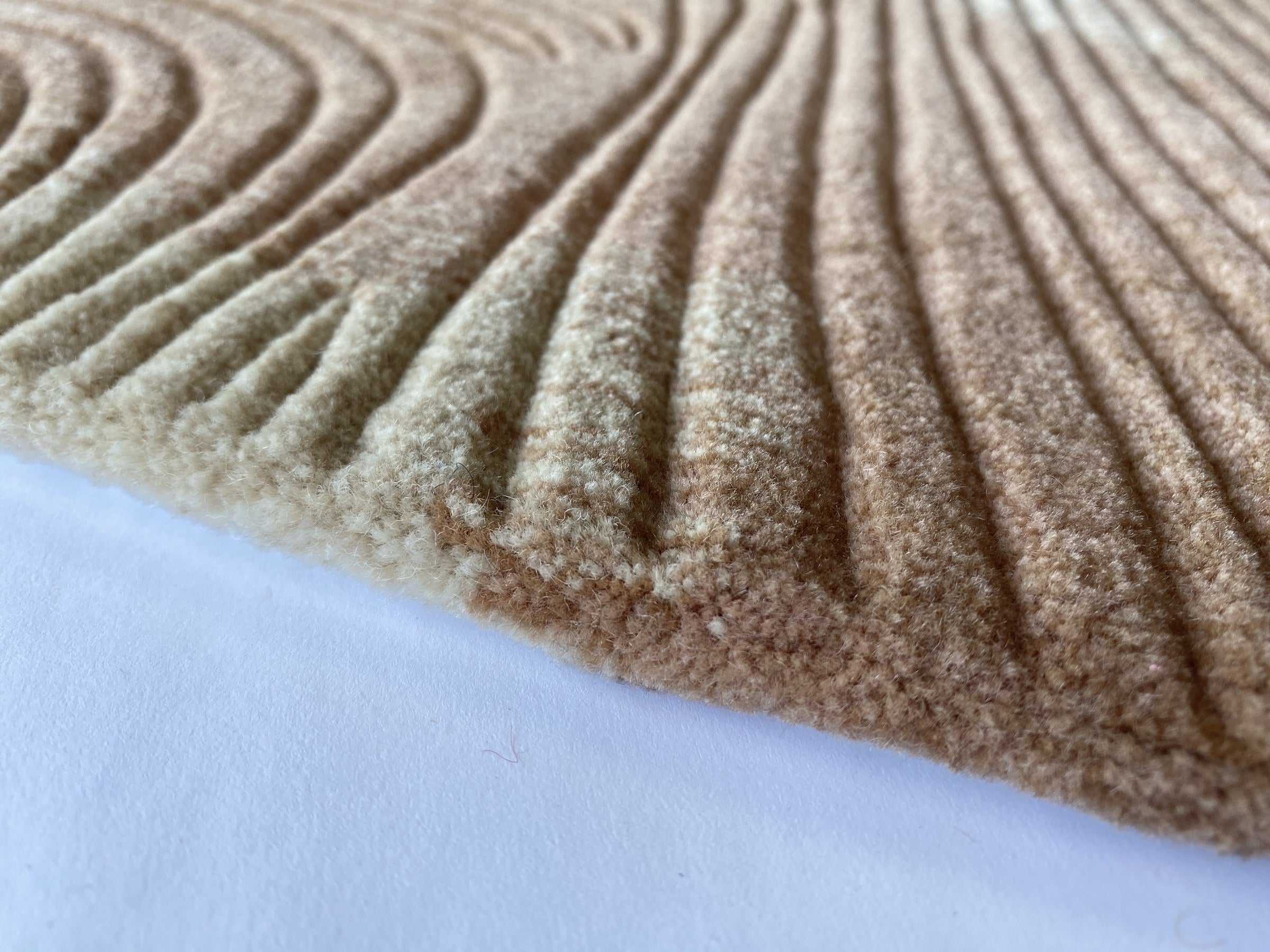 Close up of the Trove blush rug showing the cut pile and clay pink and cream markings