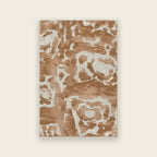 Trove hand tufted rug in blush, a tortoiseshell design in warm clay pink and cream, shown flat