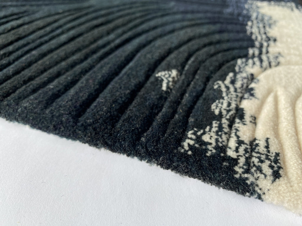 Close up of the Trove midnight rug showing the cut pile and navy and ivory markings