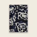 Trove hand tufted rug in midnight, a tortoiseshell design in inky navy and ivory, shown flat