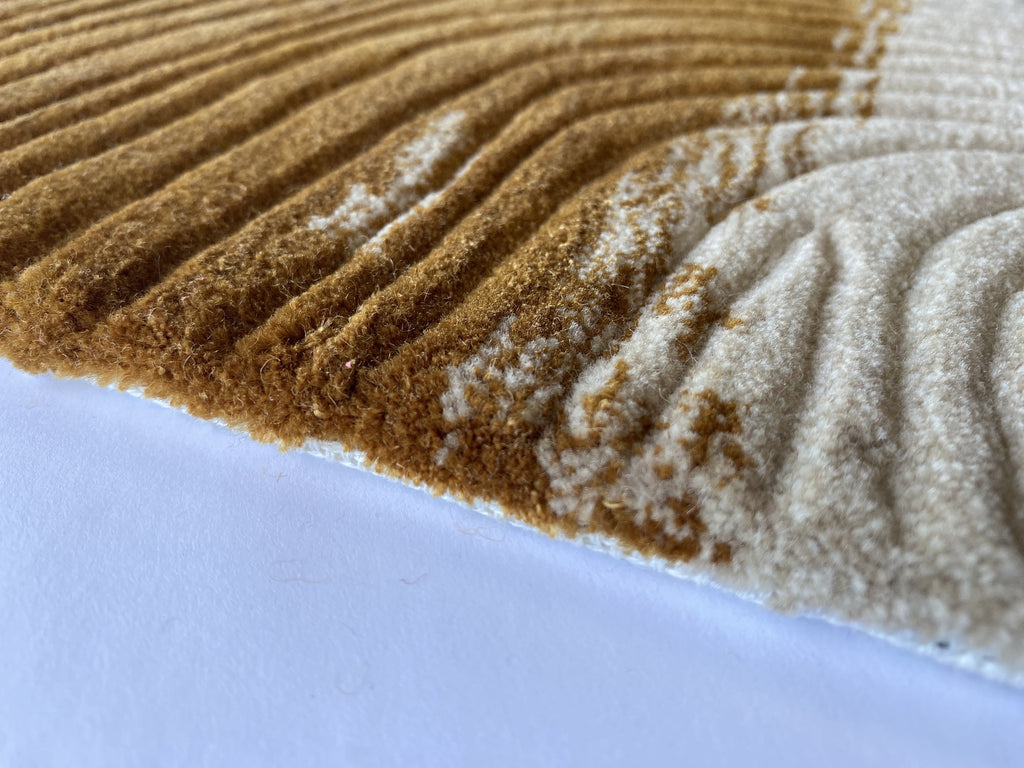 Close up of the Trove amber rug showing the cut pile and cream and gold tortoiseshell markings