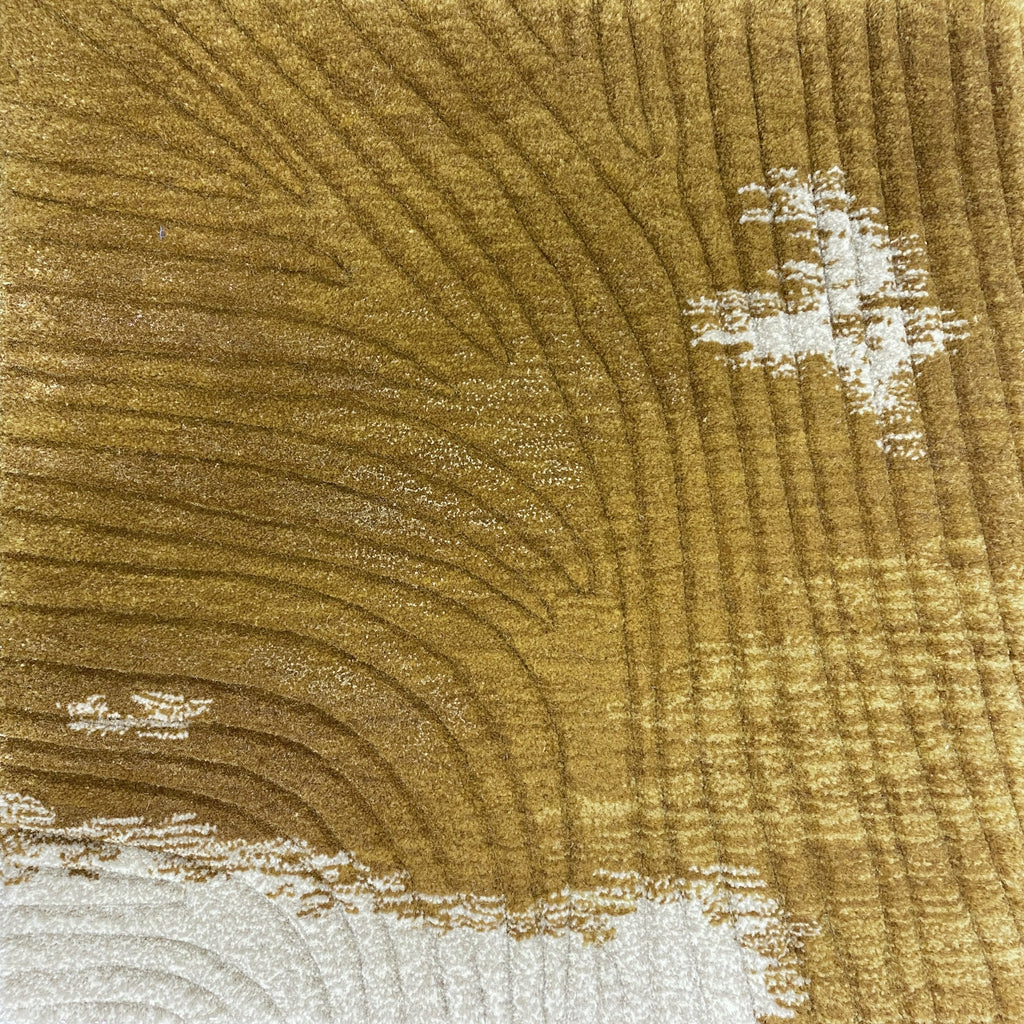 Detail of the Trove amber rug pile in warm gold wool with soft cream flecks