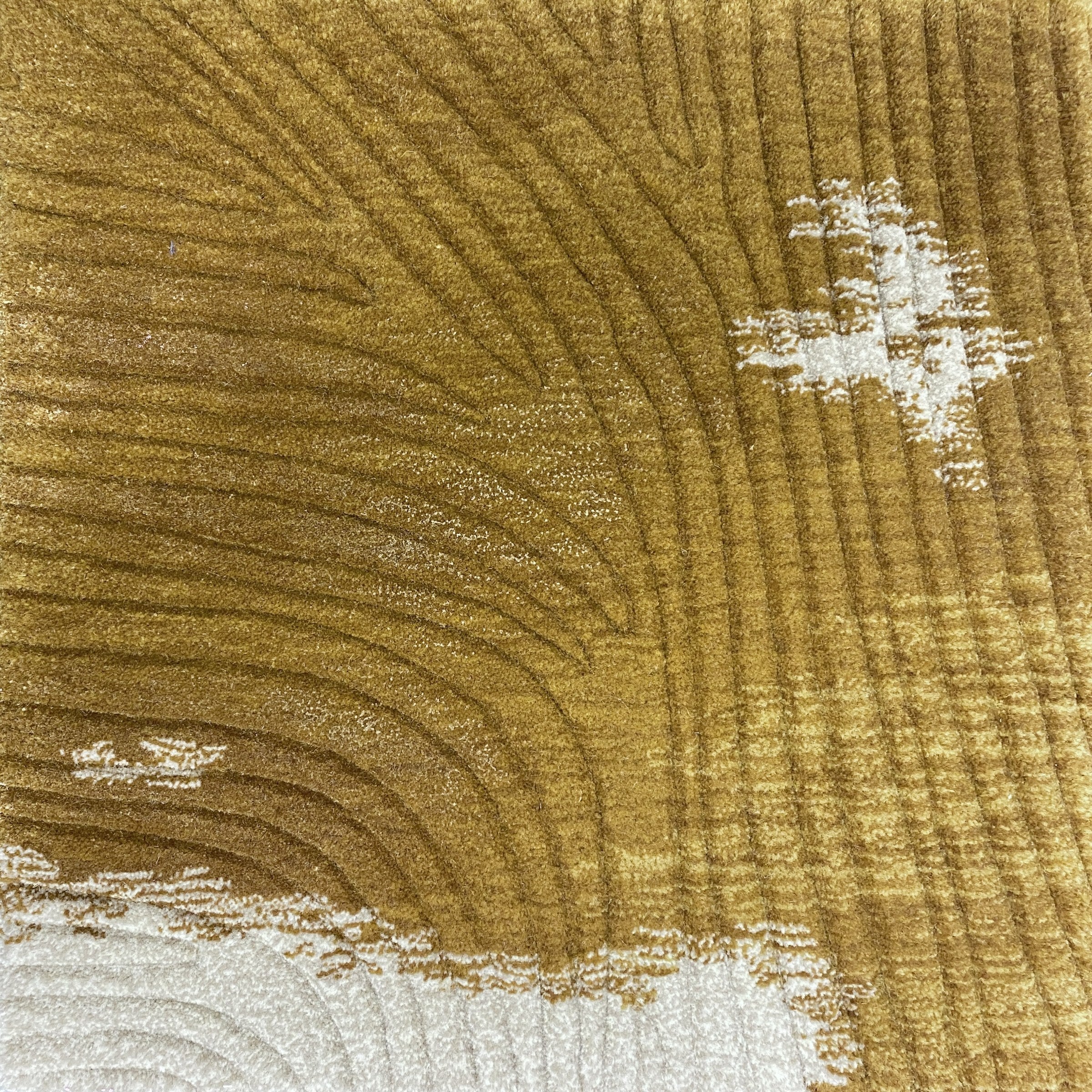 Detail of the Trove amber rug pile in warm gold wool with soft cream flecks