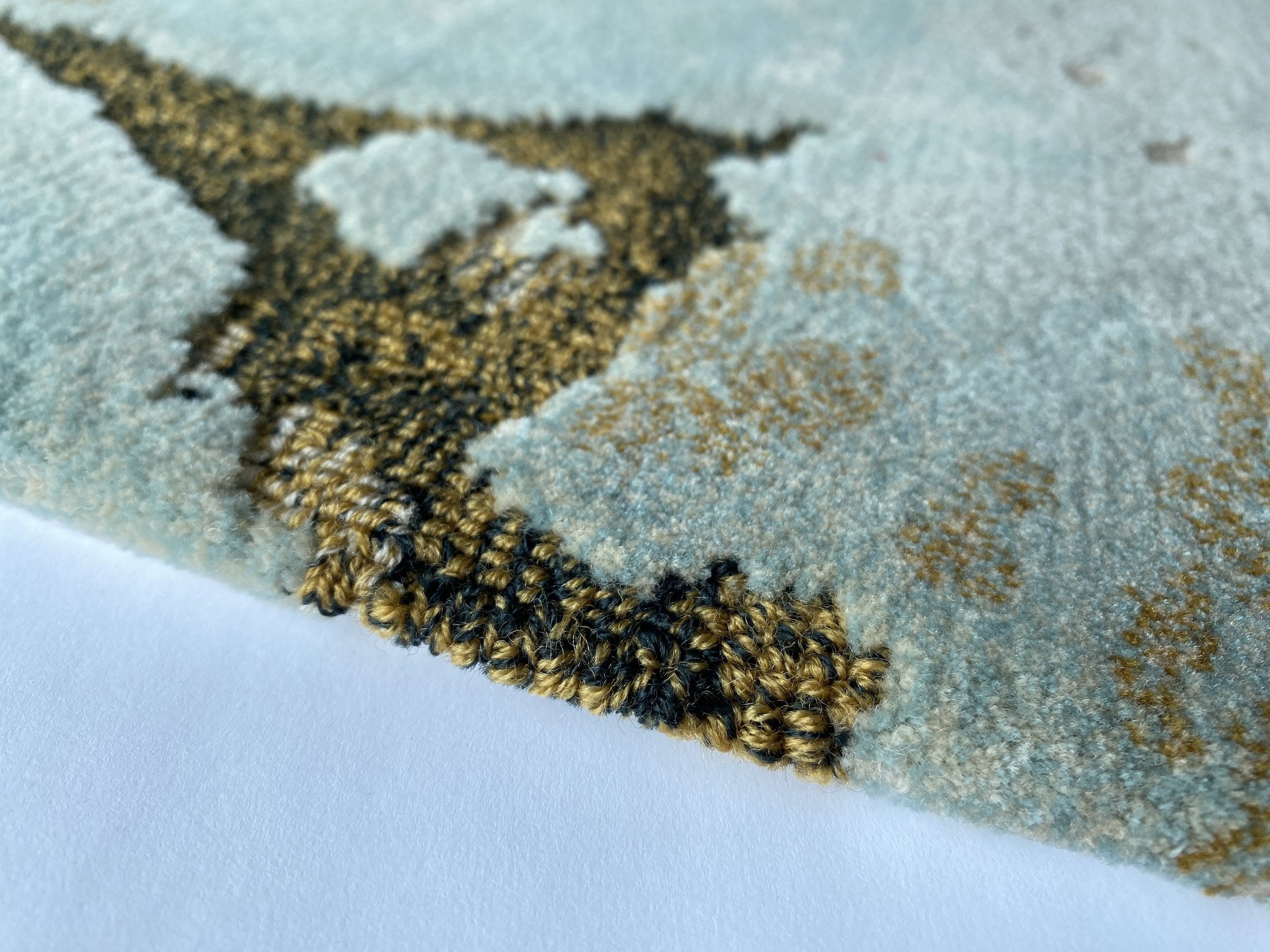 Close up of the Tundra rug showing the cut and loop pile and terrazzo flecks