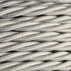 Close-up of braided fabric cable on a light gray background