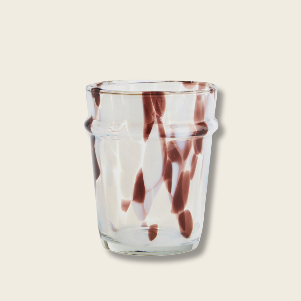 Clear glass with brown marbled design on a beige background