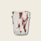 Clear glass with brown marbled design on a beige background