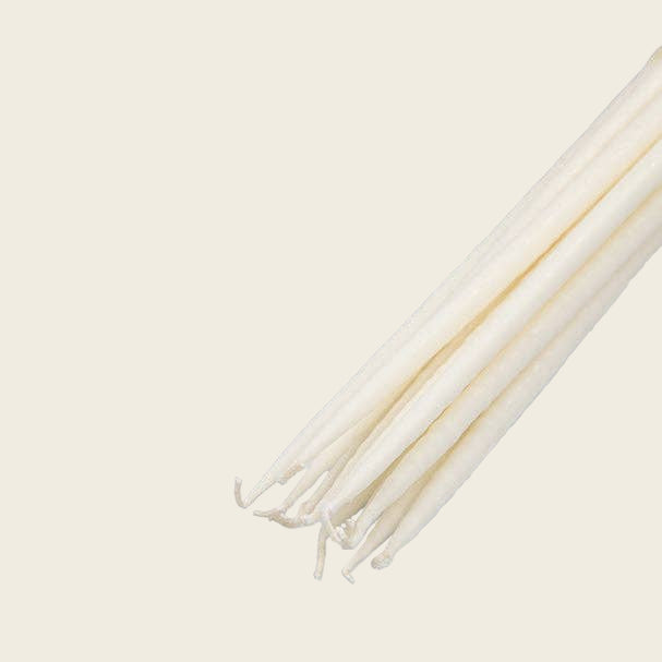 White candles on a white background
