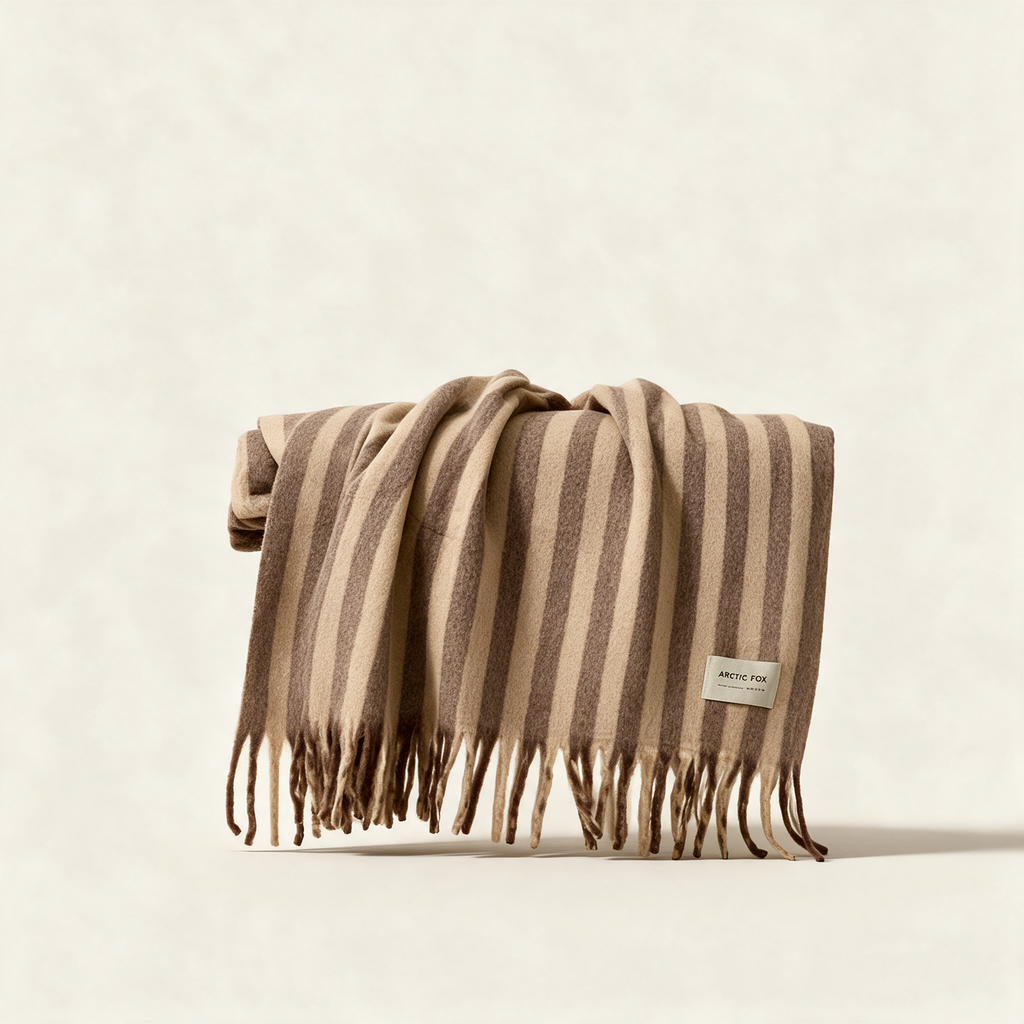 The Wool Stripe Throw in burnt umber stripe, a merino and recycled polyester blanket