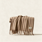 The Wool Stripe Throw in burnt umber stripe, a merino and recycled polyester blanket