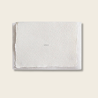 White textured towel with 'XOXO' embroidery on a light beige background